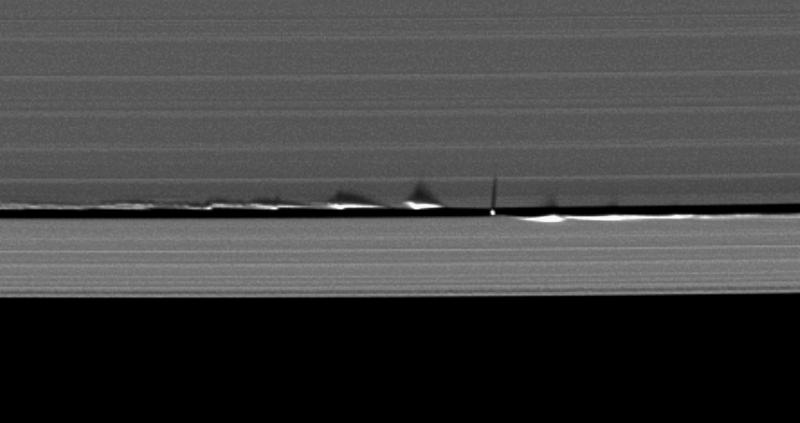 Image taken on the 11June 2009 with the rings nearly edge-on to the Sun. This shows satellite Daphnis casting its shadow onto Ring A couples with the ring disturbances caused by this satellite also casting shadows ©NASA
