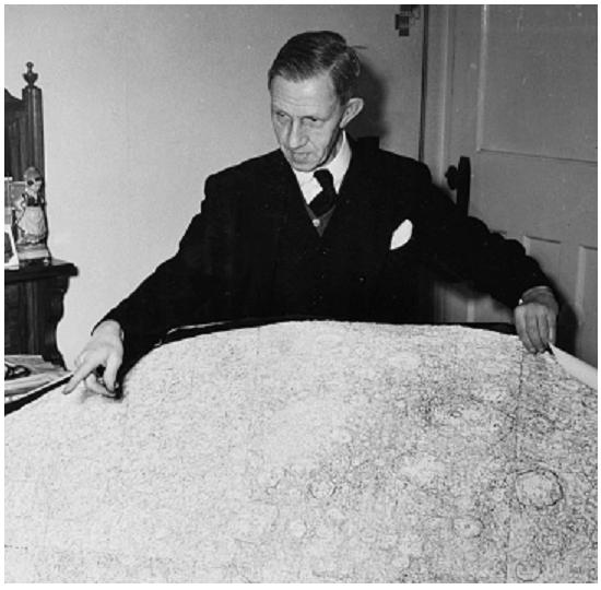 Figure 1. H. P. Wilkins at his home in Bexleyheath with his large Moon map, from the now defunct magazine 'Illustrated' (1954).
