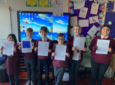 Pupils from Year 6 in St Marys Catholic School Bridgend with the paper containing their findings. Photo credit: St Marys Bridgend