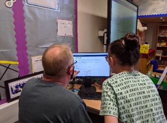 A pupil from Year 5 in Ynysowen Community School sets up an observation with the 2m Faulkes Telescope located in Hawaii telescope, from her classroom, with guidance from Prof. Paul Roche (Cardiff Uni/Faulkes Telescope Project)