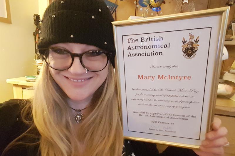 Mary McIntyre with her Sir Patrick Moore Prize certificate, presented to her at the 2021 Christmas Meeting. (Courtesy of Mary McIntyre)