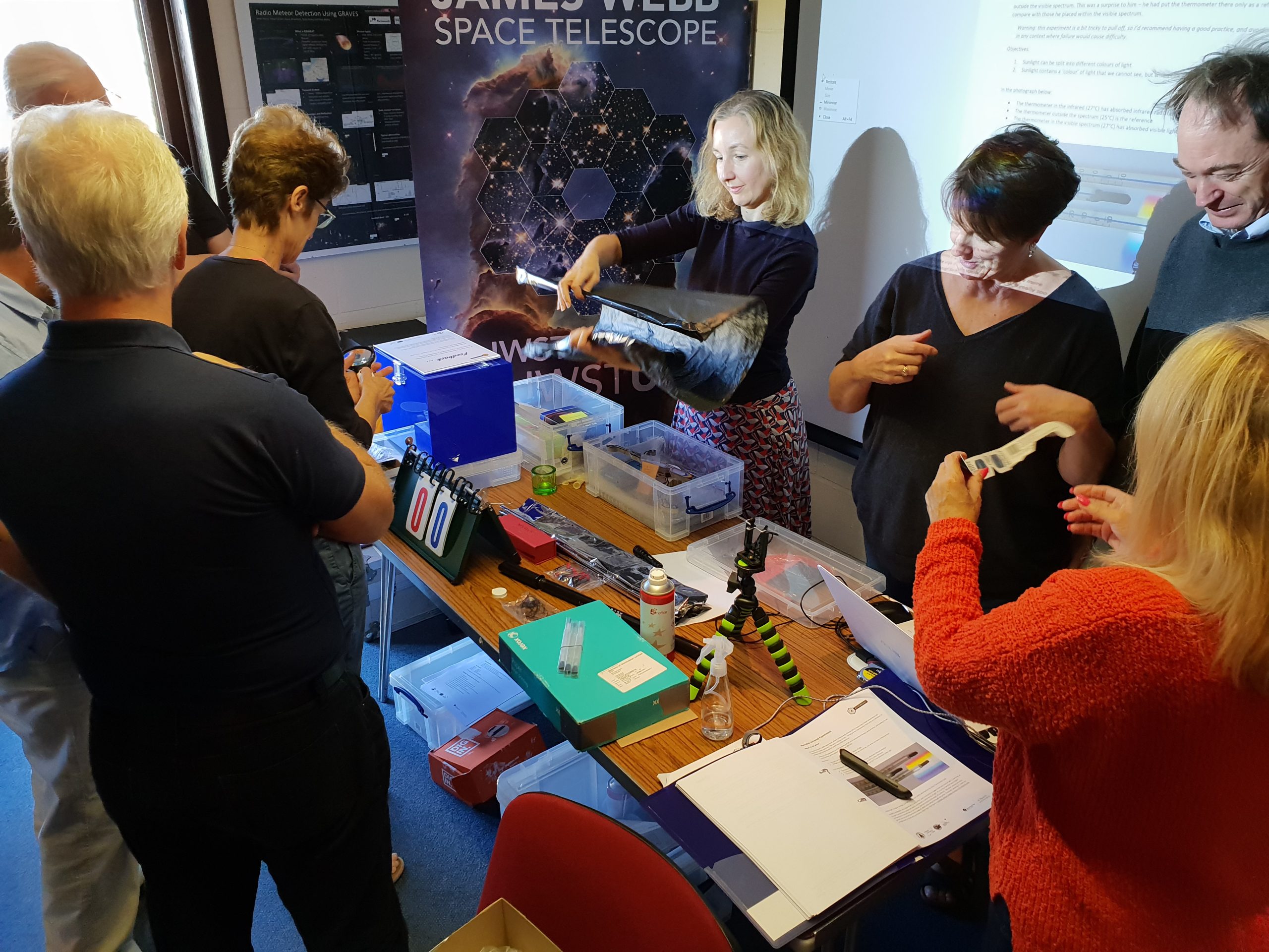 People gathered around a table of astronomy activities