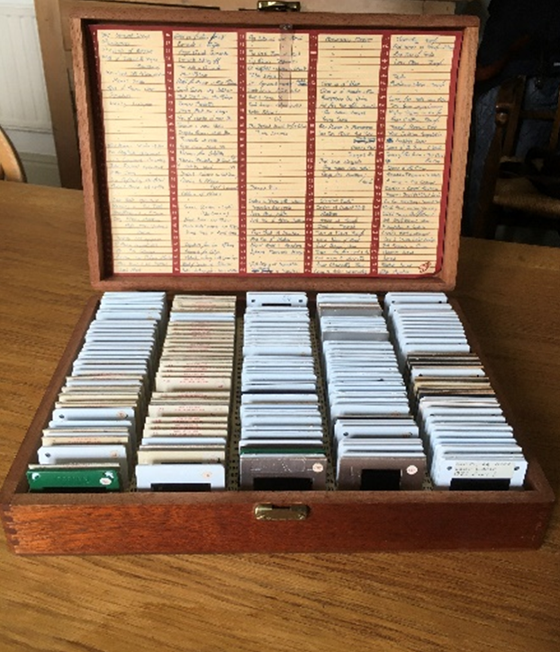 The wooden box of numerous colour slides, open on a table