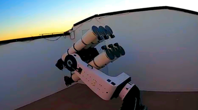 The telescope array - appearing as six white telescope tubes on a single mount - are poised towards the sky in twilight