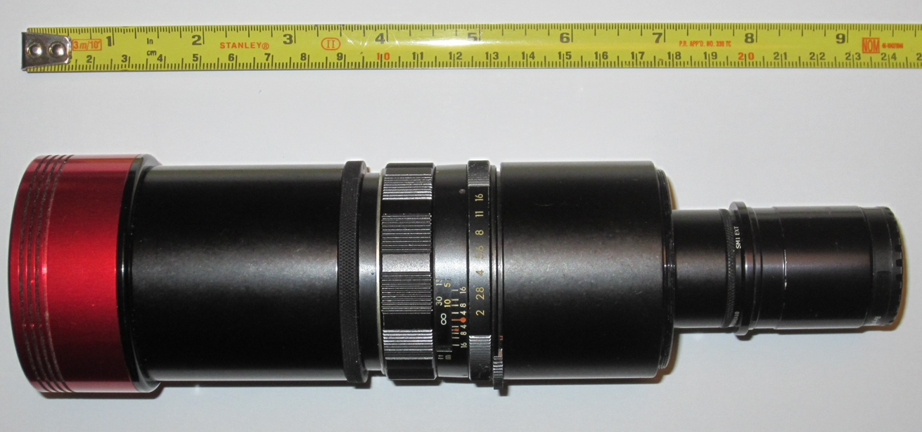 The focal reducer is red and black, with a tape measure above indicating that it is about 24 centimetres long