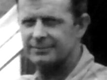 A black and white image of Merv, smiling, in middle age