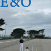 A small child launching a paper rocket in a school playground