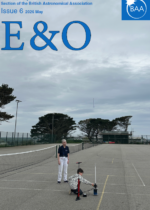 A small child launching a paper rocket in a school playground